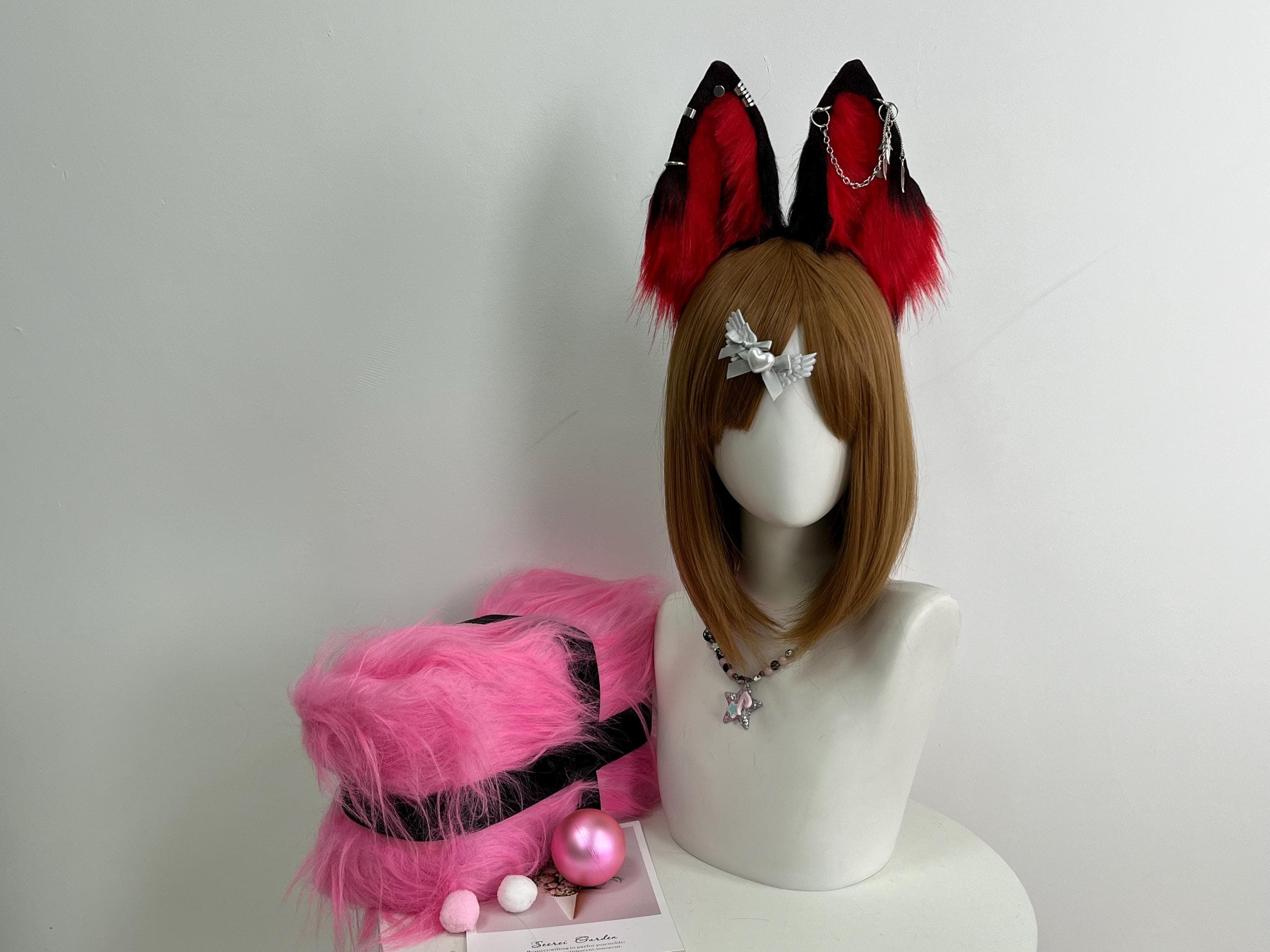 Front detail close up black red wolf ears showing layered scarlet crimson inner fur texture with natural ombre gradient from darker roots to brighter blood red tips. Dense plush faux fur stands tall and fluffy with hand trimmed tapered ear tips. Close shot for buyers who want to see the richness of the red inner color saturation the dual tone contrast against charcoal black and overall fur density quality at macro range for accurate color representation before purchase decisions.