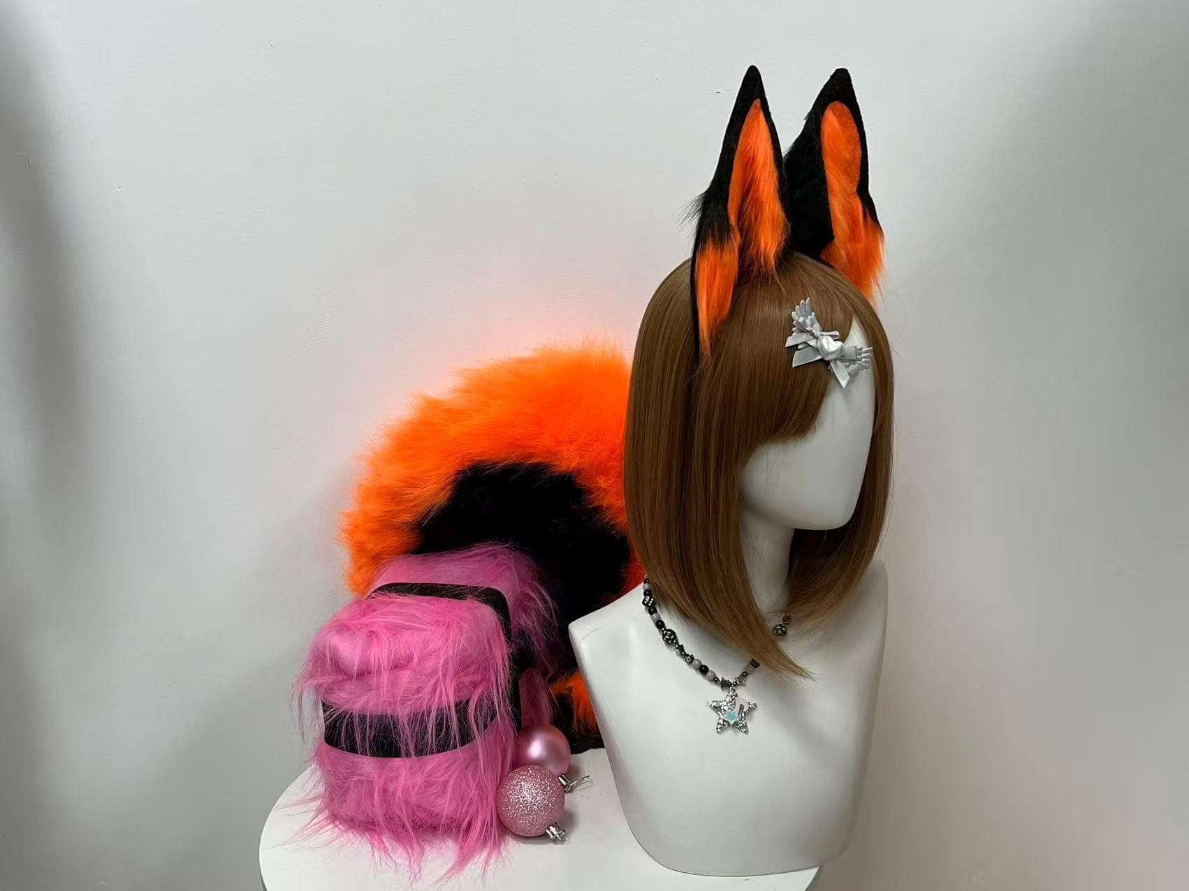 Three quarter profile side view orange and black fox ears headband plus tail set showing ear depth and bushy tail bulk from angle, handcrafted faux fur cosplay costume accessory for kitsune kemonomimi furry anime character builds. Vivid orange plush with black outline detailing creates dimensional realistic fox look for Halloween costume party anime convention rave festival photoshoot streaming prop. Lightweight comfy headband base all-day wear. Gift idea for cosplayer her him birthday.