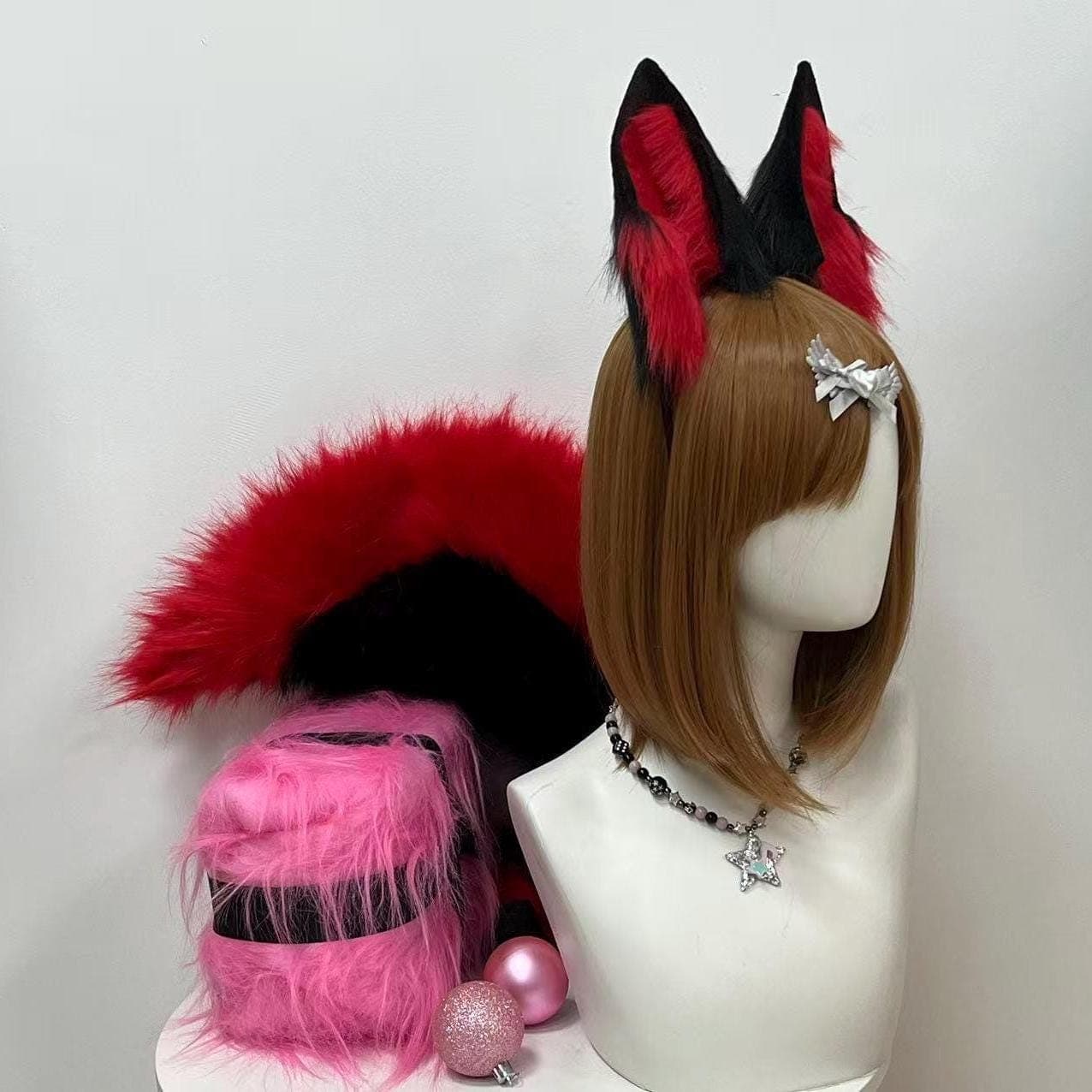 Straight on front angle black red fox ears and tail set showing symmetrical placement of both ears and the full dramatic sweep of the fox tail beside the head. The deep crimson red inner ear color pops vividly against charcoal black outer base providing strong visual contrast that photographs well on stage runway halls cosplay masquerade balls dance competitions kemonomimi themed parties and dramatic photo editorial sessions where bold animal ear and tail accents anchor the entire look.