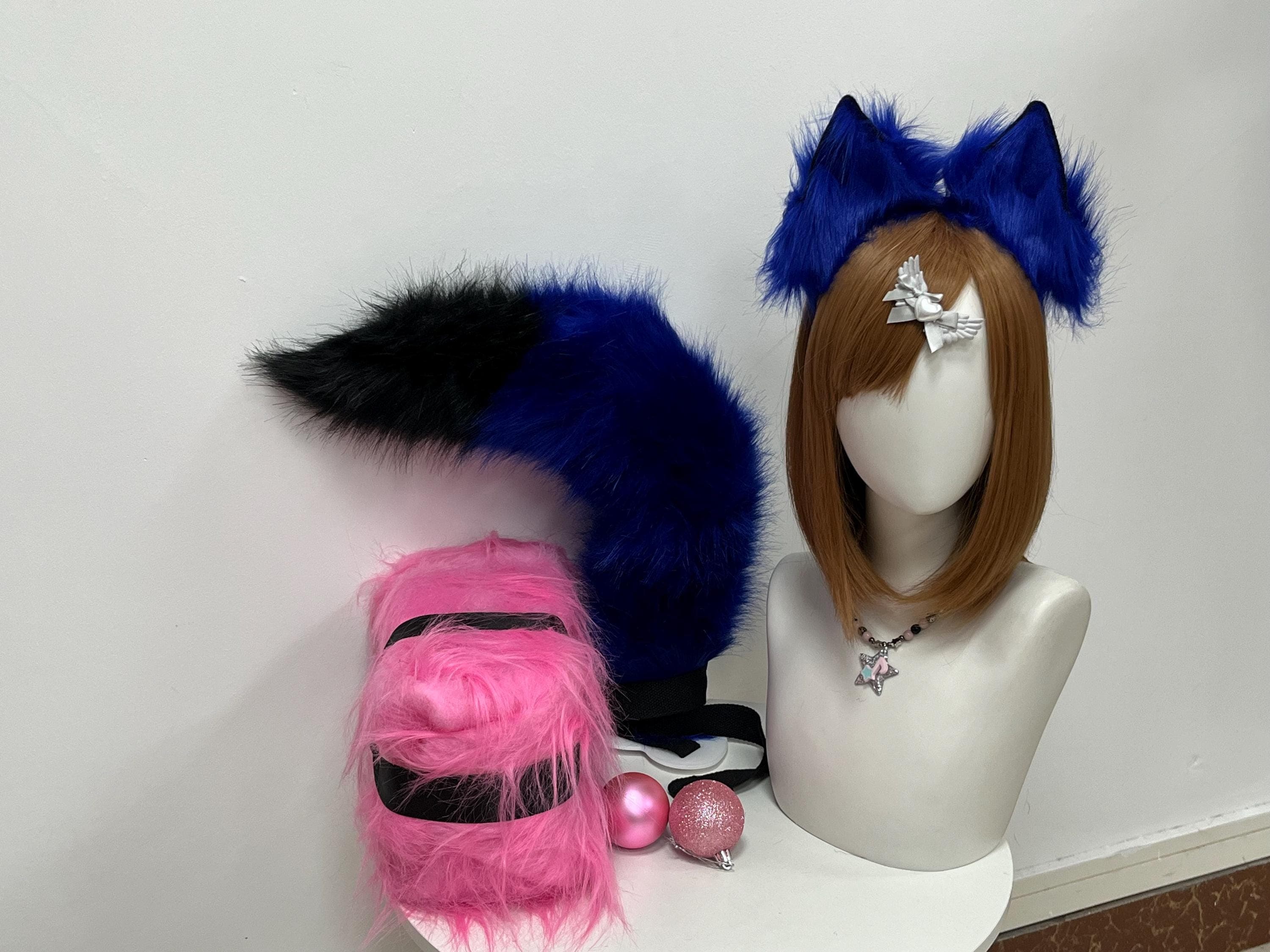 Cobalt blue fox ears and tail set displayed straight on, revealing how the deep sapphire fur holds a crisp upright shape while the matching tail drapes long and fluffy in a dramatic arc. Great pick for cosplayers building an ice midnight kitsune, twilight wolf hybrid, arctic fox spirit, or alt fashion streamer character. Dense plush pile catches studio lighting with a soft sheen that photographs beautifully under con lamps, festival strobes, and natural outdoor daylight.