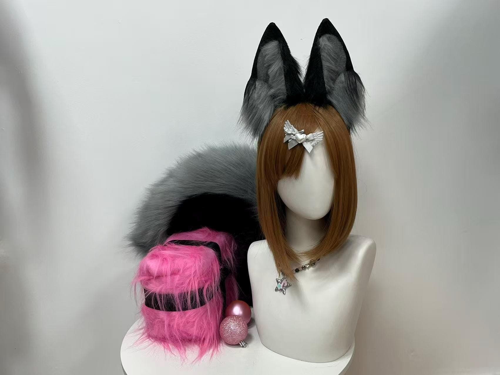 Handmade grey and black faux fur fox ears and tail set shown front view on a comfy headband, featuring tall pointed fox ear shape with soft silvery inner tufts layered over deep charcoal outer fur for a striking two tone look. Perfect kemonomimi accessory for anime conventions, Halloween costume parties, furry fursona builds, kitsune roleplay and LARP adventures. Super lightweight wire base holds its shape all day and pairs with a fluffy poseable smoky grey fox tail. Ideal cosplay gift idea.