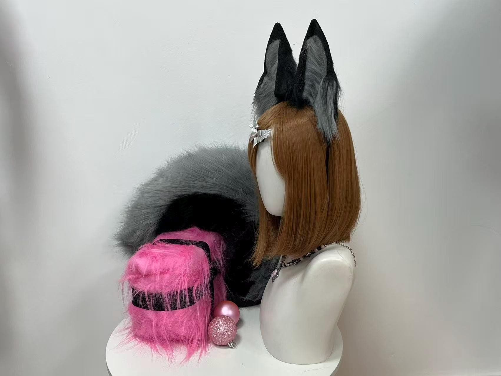 Side profile angle of the grey and black fox ears and tail set highlighting the long bushy tail draped behind, showing how the ashy charcoal and dusky slate fur blends into dark tips for a realistic timber wolf hybrid vibe. Great for furry convention photoshoots, kemonomimi streamer setups, Halloween witch looks, petplay gear, goth alt fashion, and dark cottagecore outfits. The ears sit angled naturally, mimicking a wild fox listening, while the tail curves with soft organic movement.