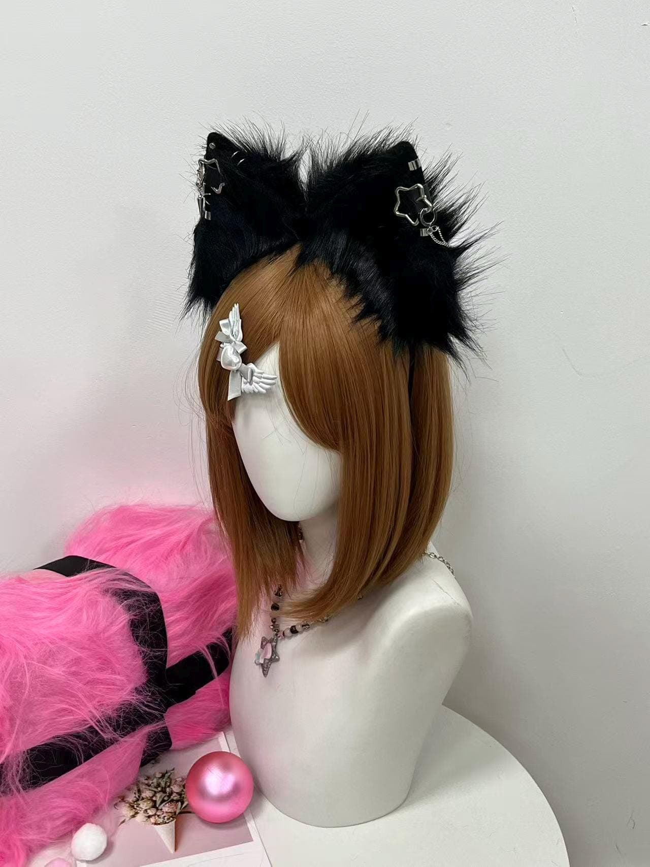 Three quarter angle of the black fluffy fox ear headband revealing rounded depth, ear symmetry, and the way the raven fur stands up in a bushy natural arc. Ears lean slightly forward giving off alert wild animal energy. Perfect for cosplayers photographing a midnight wolf, midnight kitsune, vampire familiar, dark fae, or gothic fursona at con photo ops. Strong contrast between pitch black fur and shiny silver chain piercing hardware pops dramatically on camera with any lens setup.