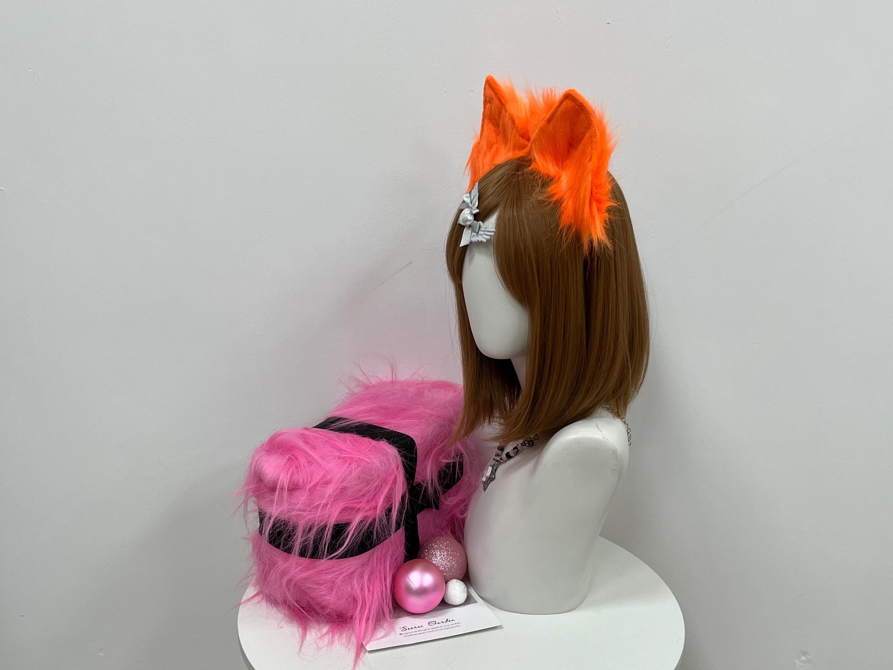 Side profile view of the orange fox ears in worn position, showing the slim band footprint and how each ear tilts slightly forward in an attentive pose. Dense neon fur creates a pillowy halo while staying soft enough for full convention days. Ready-to-wear addition for fire kitsune, anime familiars, autumn forest sprite kits, masquerade looks, and Halloween throw-on costumes craving maximum impact across long con weekends and meetups in crisp autumn parks.