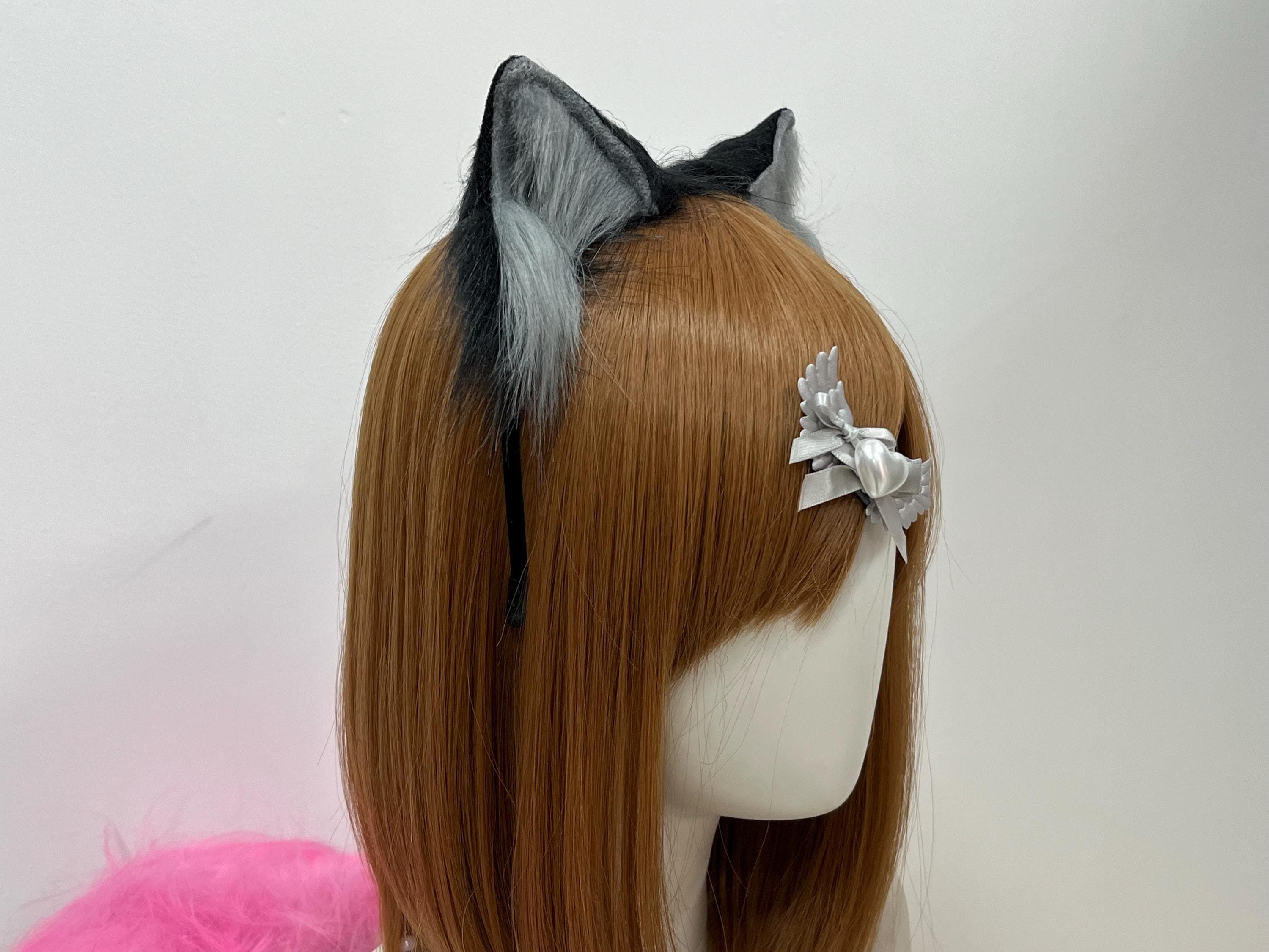 Profile detail of the realistic wolf ears showing the silvery grey inner cup flaring open and the cool charcoal outer coat swept back into a natural tapered tip. The low-profile build keeps this pair anchored through convention dance circles, renaissance joust crowds, and therian forest walks alike. A staple piece for anyone building a wild kemonomimi lookbook or piecing together a modular cosplay accessory stash for quick character swaps between sets.
