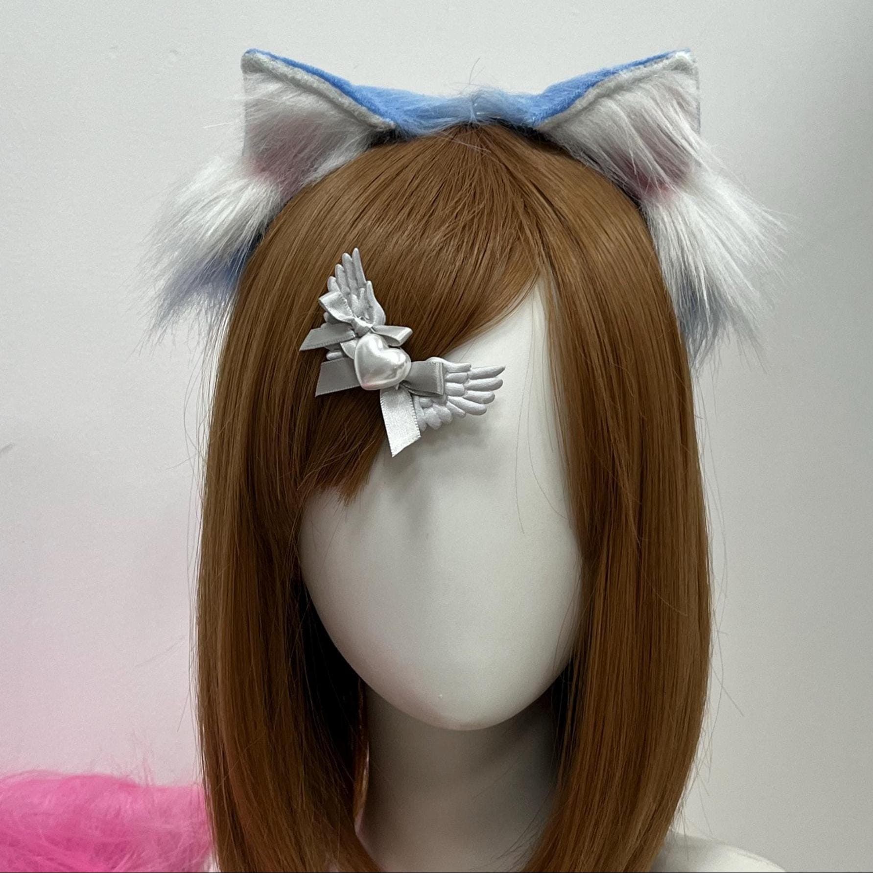 Dreamy sky blue wolf ears headband in crisp close-up: the outer fur is a soft cerulean wash shading into creamy white inner tufts with pale pink undertones at the base. The ergonomic arch hugs the head comfortably, the pointed tips tilt naturally like a real timberwolf, and the hand-shaped faux fur catches light exactly how therian and kemonomimi cosplayers want for anime con selfies, festival sets, Halloween shoots, and lively LARP roleplay looks.