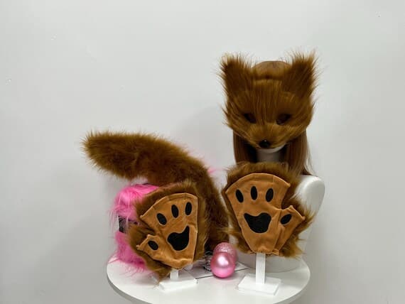 Transform into a playful fox with this plush set of fox ears, paws, and tail made from soft faux fur. The set is designed for cosplay, furry costumes, and Halloween parties. The fox ears are lightweight and easy to wear, while the paws feature a furry texture for added realism. The tail clips on effortlessly, completing the look for animal roleplay or creative costume ideas. Perfect for cosplay conventions, photoshoots, or furry fandom events