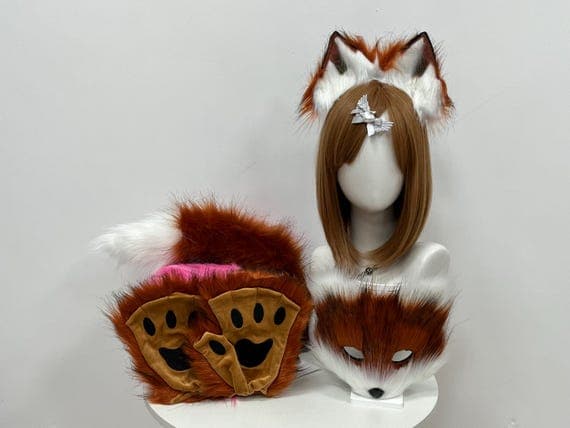 This cute and realistic cat set features brown and white faux fur, making it the perfect accessory for Halloween, cosplay, or fursuit enthusiasts. The ears are attached to an adjustable headband, the paws are plush and comfortable, and the tail adds an authentic touch. Wear it for petplay, conventions, or as a fun costume for any occasion. Customizable options are available to suit your individual needs.
