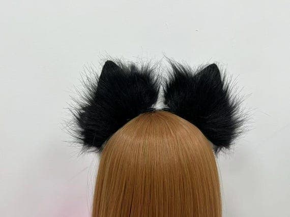Close-up of black fox ears headband on a model, showing fluffy faux fur texture and secure fit. Ideal for Halloween, anime cosplay, and party costumes.
