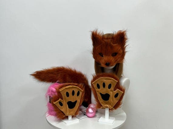 Complete fox costume accessory set featuring plush fox ears, paws, and a fluffy tail, all crafted from soft faux fur for a realistic look. The ears are designed to fit comfortably for all-day wear during cosplay or Halloween events. The paws have a detailed, furry texture, perfect for animal-themed parties. The tail attaches easily with a clip, making this set ideal for cosplay conventions, furry photo shoots, and creative costume designs