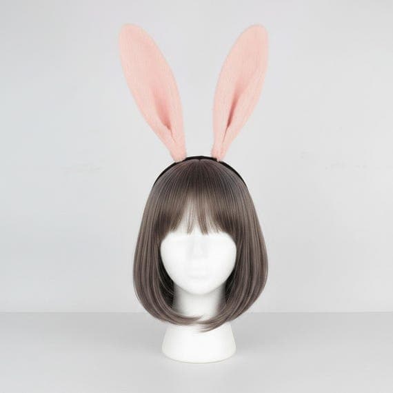 Classic plush rabbit ears headband in soft pretty pink displayed on a mannequin head with styled wig. Extra tall 24cm dense fluffy faux fur bunny ears on a comfortable padded black headband weighing 65g. Full-size rabbit costume accessory with luxuriously thick plush texture ideal for Halloween bunny outfits, Easter celebrations, cosplay conventions, anime events, kawaii themed parties, photo shoot props, and dress-up occasions. Also available in black, grey, and white-pink color variations