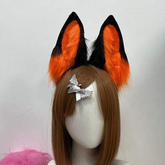 Custom orange and black wolf ears crafted from soft faux fur on a flexible headband, perfect for cosplay characters, Halloween wolves, or furry style. Handmade for comfort and realism, these ears elevate your cosplay look with a fierce wild animal aesthetic. Great for conventions, pet play costumes, or gothic-themed cosplay. Faux fur cosplay ears with a custom color blend for a unique and eye-catching wolf design.