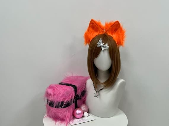 Cute and realistic cat ears headband in black and pink faux fur, designed for cosplay, petplay, or casual wear. The soft, adjustable headband features a fluffy finish and is a popular accessory for anime lovers, furry enthusiasts, and Halloween parties. Available in multiple colors like white, brown, and gray. This high-quality, handmade piece adds the perfect touch to any costume or themed event