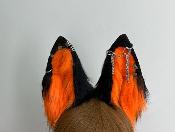 Custom orange and black wolf ears crafted from soft faux fur on a flexible headband, perfect for cosplay characters, Halloween wolves, or furry style. Handmade for comfort and realism, these ears elevate your cosplay look with a fierce wild animal aesthetic. Great for conventions, pet play costumes, or gothic-themed cosplay. Faux fur cosplay ears with a custom color blend for a unique and eye-catching wolf design.