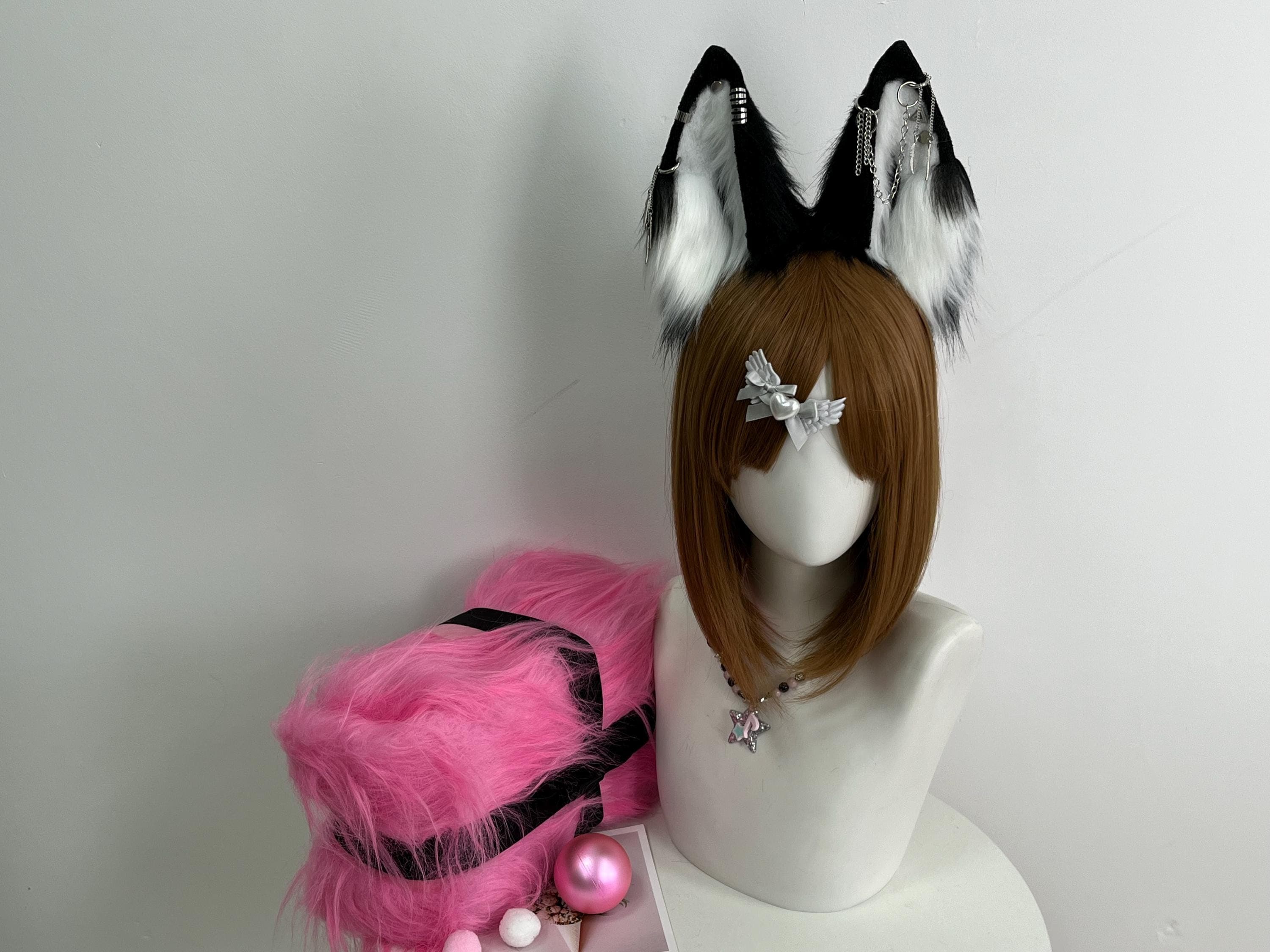 Realistic black and white faux fur wolf ears headband front view with silver chain piercing accents, jet black outer fur and white plush inner fluff creates striking gothic punk therian wolf look perfect for Halloween cosplay costume anime convention. Handmade kemonomimi style ears with decorative metal ear cuffs dangling feather charms and bar detail unique alt fashion statement. Slim comfortable headband base lightweight all-day con wear. Gift idea for wolf lover furry cosplayer birthday.