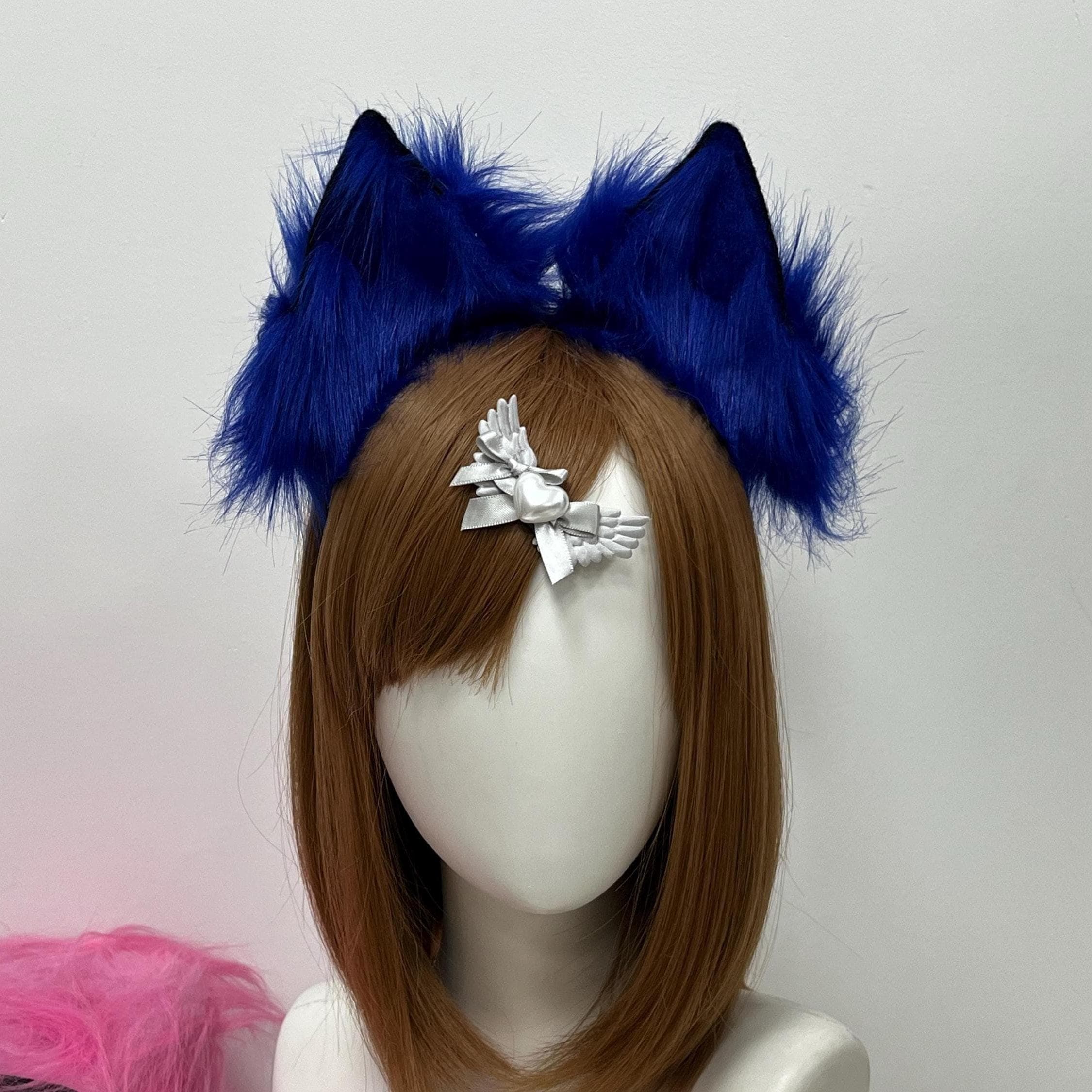 Front view close-up of royal blue faux fur wolf ears mounted on a slim headband, showing the full sculpted silhouette and electric cobalt plush colorway. Subtle dark navy tipping along the inner ear edges adds a gothic moonlight edge while soft brushed fibers catch the studio light. A perfect drop-and-go kemonomimi piece for first-day con runs, hallway photo ops and lupine OC builds when you want a saturated bold pop of color sitting above your bangs all weekend long.