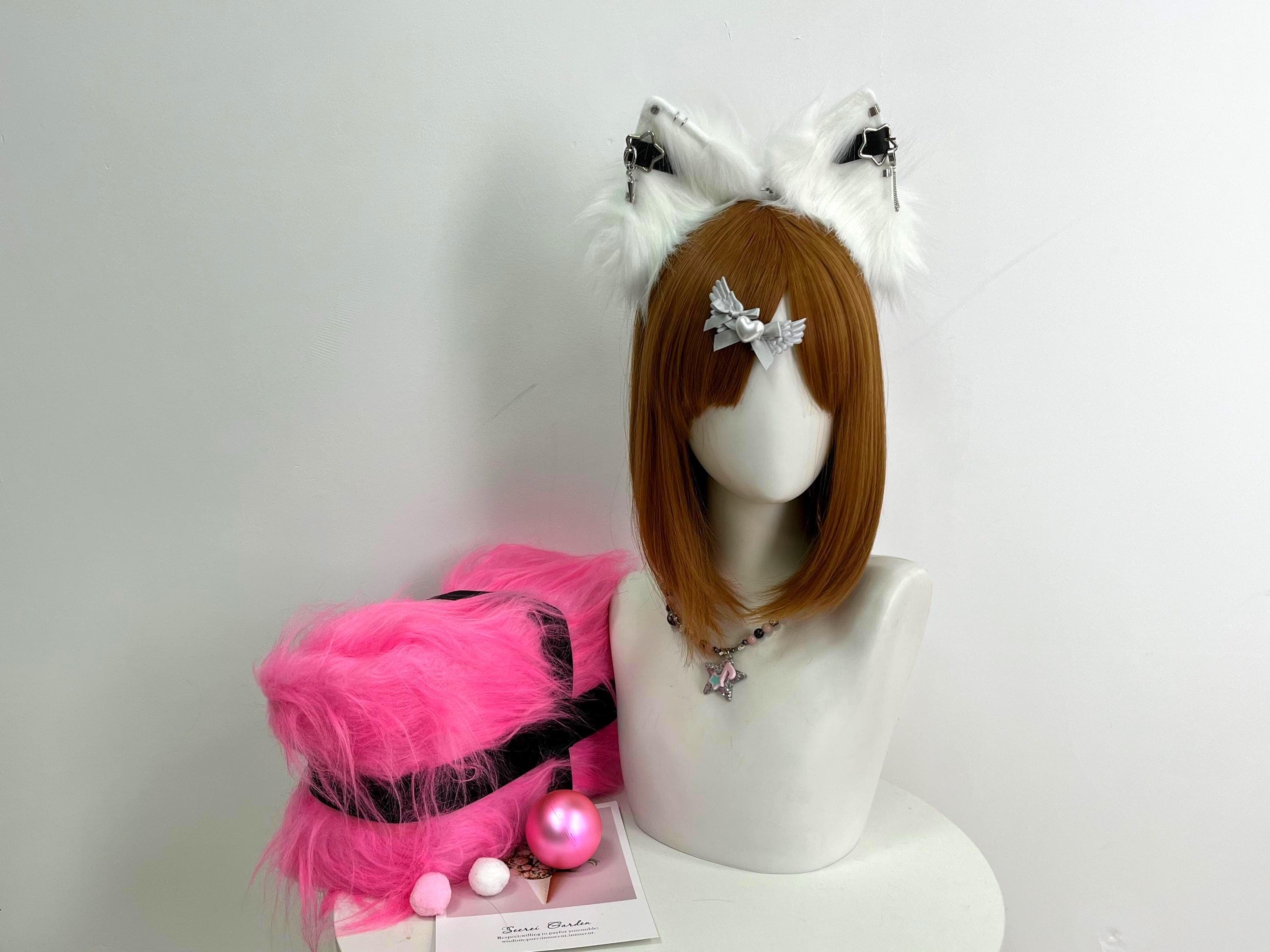 Handmade white faux fur cat ears headband displayed front view, featuring tall pointed kitty ear shape with fluffy snow white fur and silver chain piercings with black star buckle accents for a gothic anime cosplay vibe. Perfect kemonomimi accessory for catgirl roleplay, manga conventions, Halloween costume nights, therian fursona builds, and pastel goth streetwear. Lightweight comfy headband stays put for hours of wear and looks striking paired with a lolita or harajuku outfit.