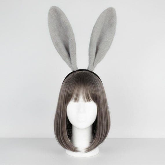 Rear view of classic plush rabbit ears headband on mannequin head with dark brown wig showing back of tall ears, padded black headband visible across back of head, warm beige background.